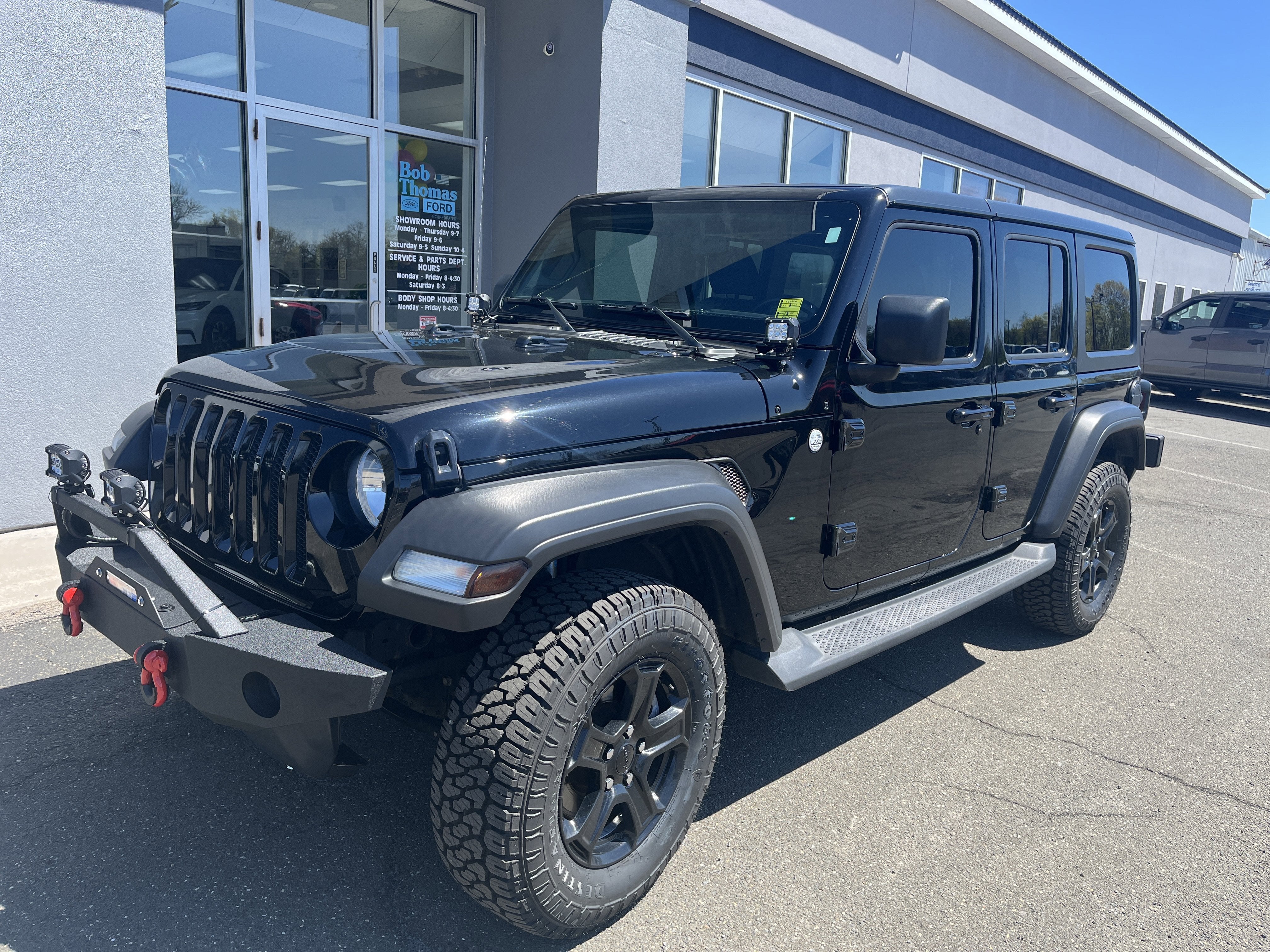 2021 Jeep Wrangler Unlimited Sport S in Black Clearcoat — front three-quarter view